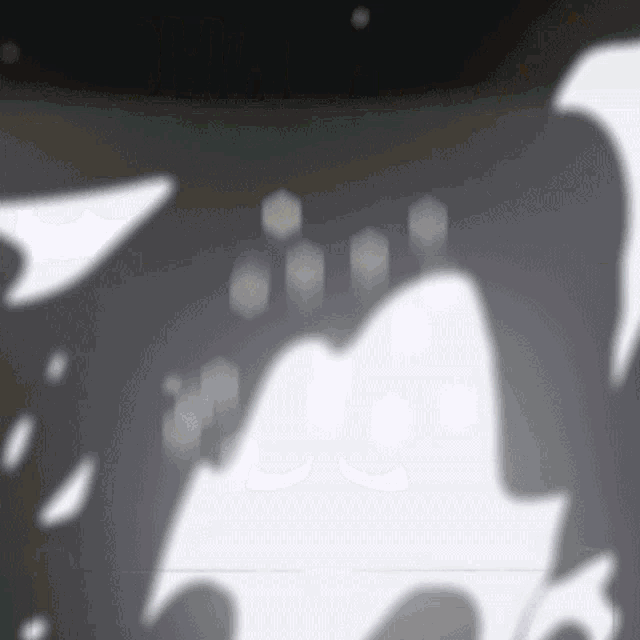 a shadow of a person 's face is cast on a wall .