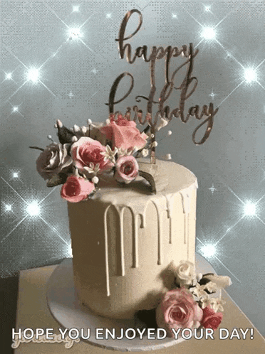 a birthday cake with flowers and a happy birthday sign