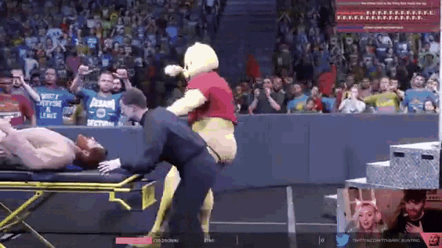 a man in a winnie the pooh costume is helping a man on a stretcher