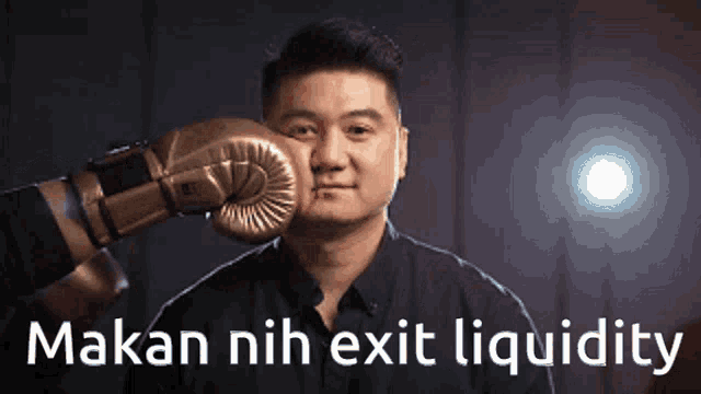 a man with a boxing glove on his face and the words makan nih exit liquidity below him