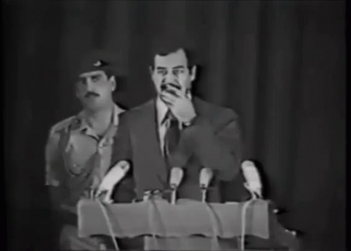 صدام حسين يدخن دخان سيجار كلمة البرلمان GIF - Saddam Hussein Smoking Cigar Parliament Speech GIFs