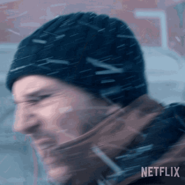 a blurry picture of a man wearing a hat and a netflix logo