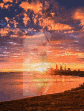 a sunset over a body of water with a woman 's face visible