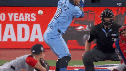 a baseball player with the number 0 on his jersey swings at a ball