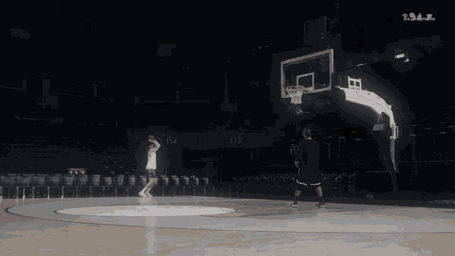 two basketball players are playing on a court with the number 114 and 113 visible
