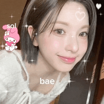 a close up of a woman 's face with a heart on her forehead and a hello kitty sticker .