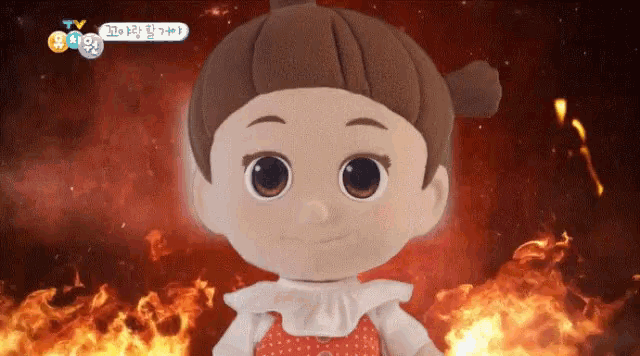 a stuffed doll is standing in front of a fire with a tv logo above it
