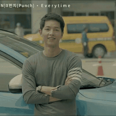 a man with his arms crossed stands in front of a blue car with the words punch everytime written on the bottom right