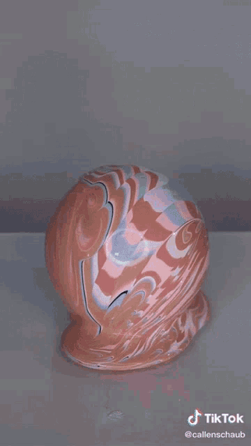 a tiktok video of a marbled ball with a bubble in it