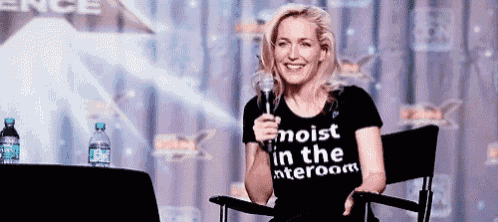 a woman wearing a t-shirt that says noist in the interroom