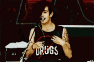 a man wearing a shirt that says drugs is dancing