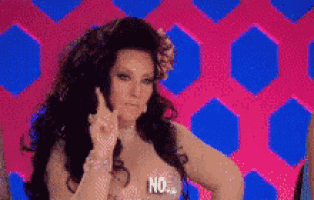 a woman with a flower in her hair is giving the middle finger and saying no