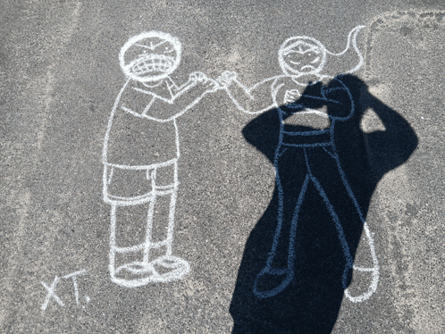 a chalk drawing of a boy and a girl with the letters xt on the bottom right