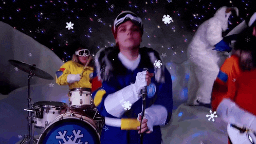 a man in a snow suit sings into a microphone