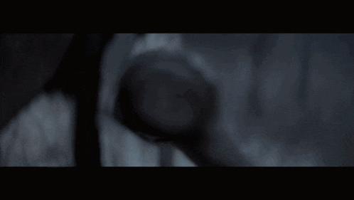 a close up of a monster 's face with a dark background