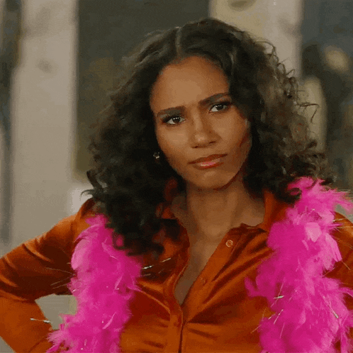 a woman wearing a red shirt and a pink boa around her neck