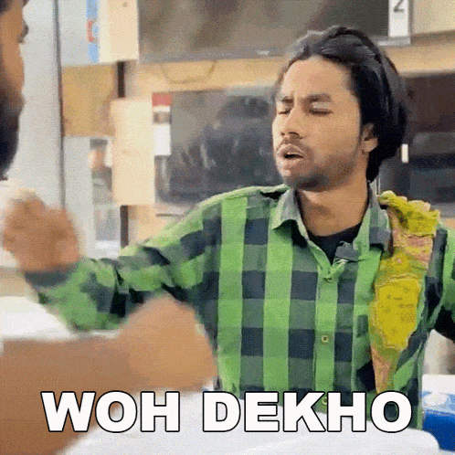 a man in a green and black plaid shirt says wah dekho