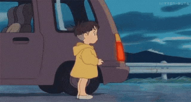 two little girls are standing next to a car .