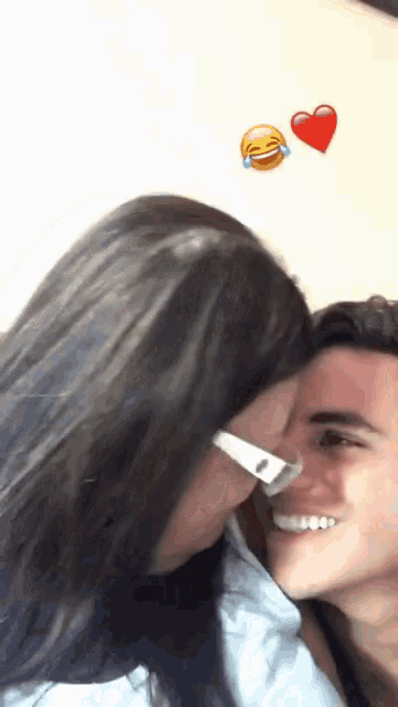 a woman kissing a man on the cheek with a heart and a smiley face behind them