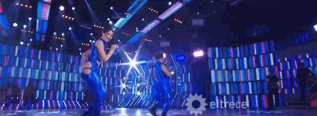 a group of people dancing on a stage with eltrece written on the bottom