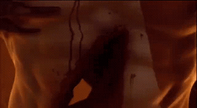 a close up of a statue of a man with a sword in his hand in a dark room .