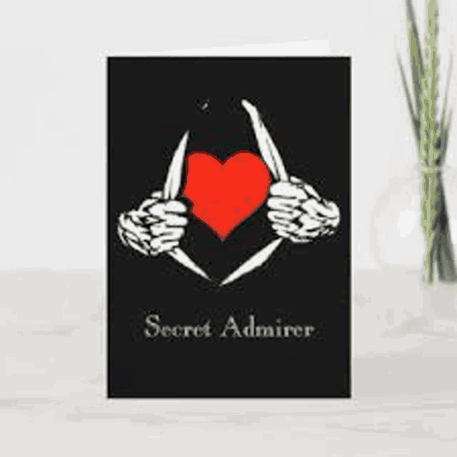 a greeting card with a skeleton holding a red heart and a knife .