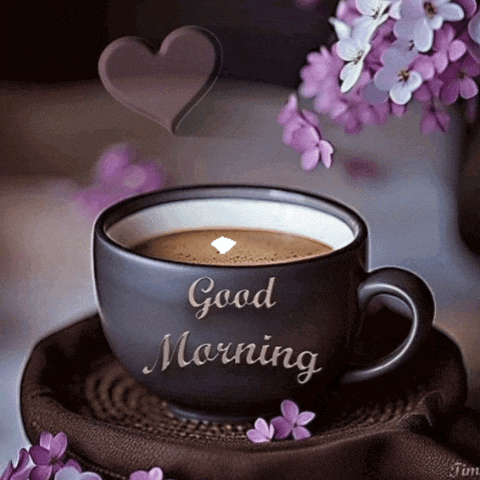a cup of coffee with purple flowers and a heart that says good morning