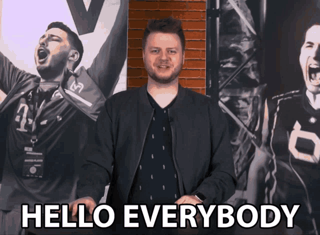 a man says hello everybody in front of a brick wall