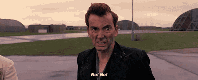 a man in a black suit says no no