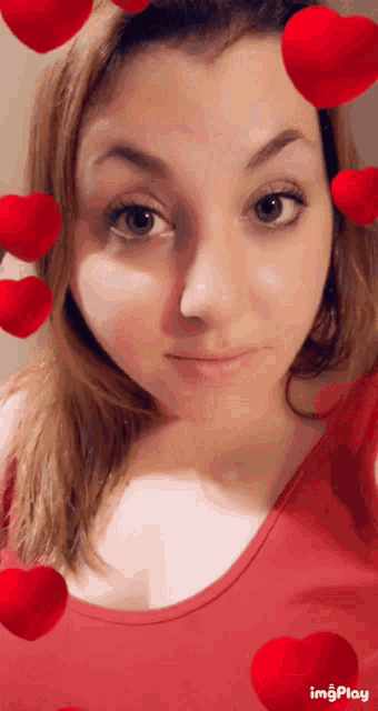 a woman in a red tank top is surrounded by red hearts and says imgplay at the bottom