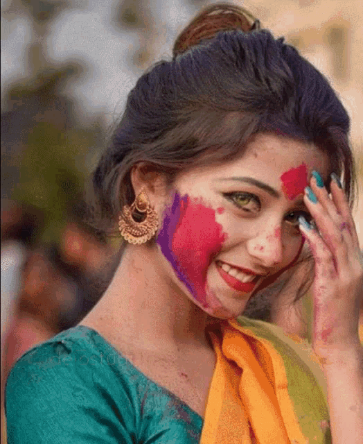 a woman with paint on her face is smiling