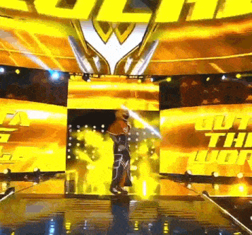 a man in a costume is standing on a stage in front of a large screen that says ' the lion '