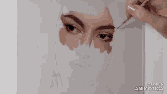 a person is drawing a woman 's face with a brush .
