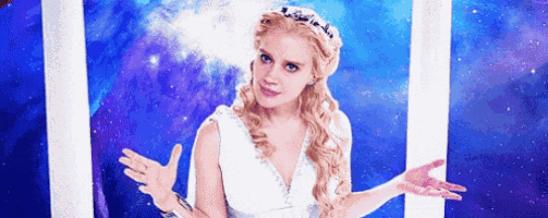 a woman in a white dress and tiara is standing in front of a blue sky .