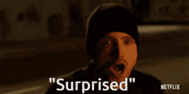 a man with his mouth open and surprised written on the screen