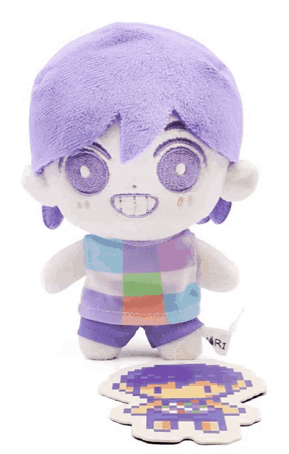a stuffed toy with purple hair has a tag that says ari