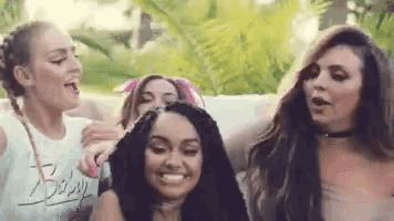 a group of women are standing next to each other in a park .