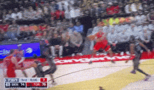 a blurry picture of a basketball game between the tangerine and the raptors