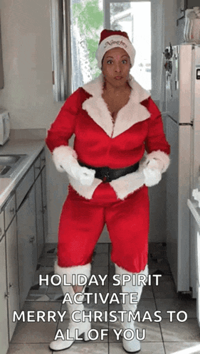 a woman in a santa suit is dancing in a kitchen