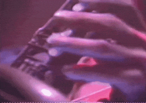 a close up of a person playing a saxophone in a dark room