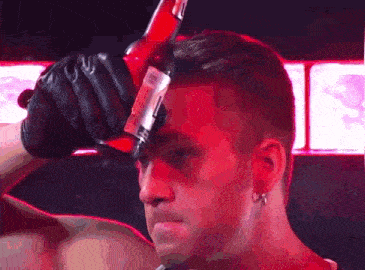 a man is holding a red bottle with a label that says ' a '