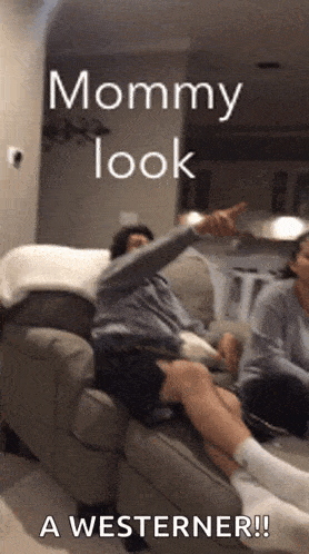 a man sitting on a couch with a caption that says mommy look