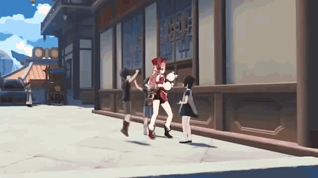 a group of girls are standing on a sidewalk in front of a building .