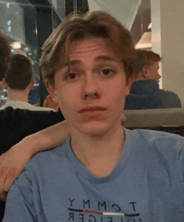 a young man wearing a tommy hilfiger shirt