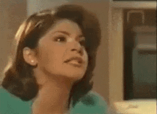 a woman is making a funny face in front of a sign that says bruh