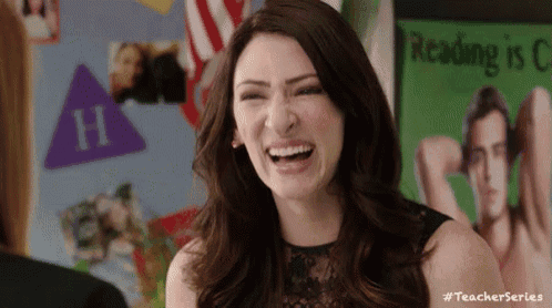a woman is laughing in front of a poster that says reading is fun .