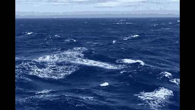 a large body of water with waves crashing against the shore