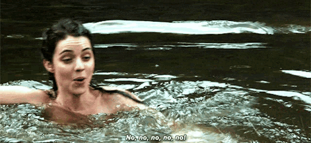 a woman is swimming in a river and says no no no no no !