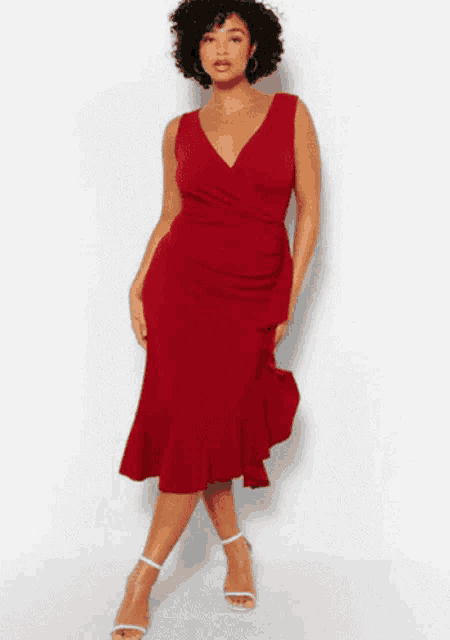 a plus size model is wearing a red dress with a ruffled skirt