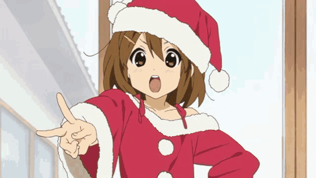 a girl in a santa hat is pointing